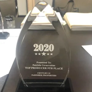 A glass award sitting on top of a table.