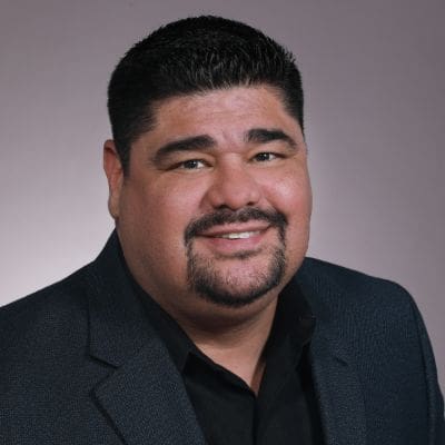 A man with a beard and mustache wearing a suit.