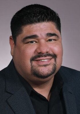 A man with a beard and mustache wearing a suit.