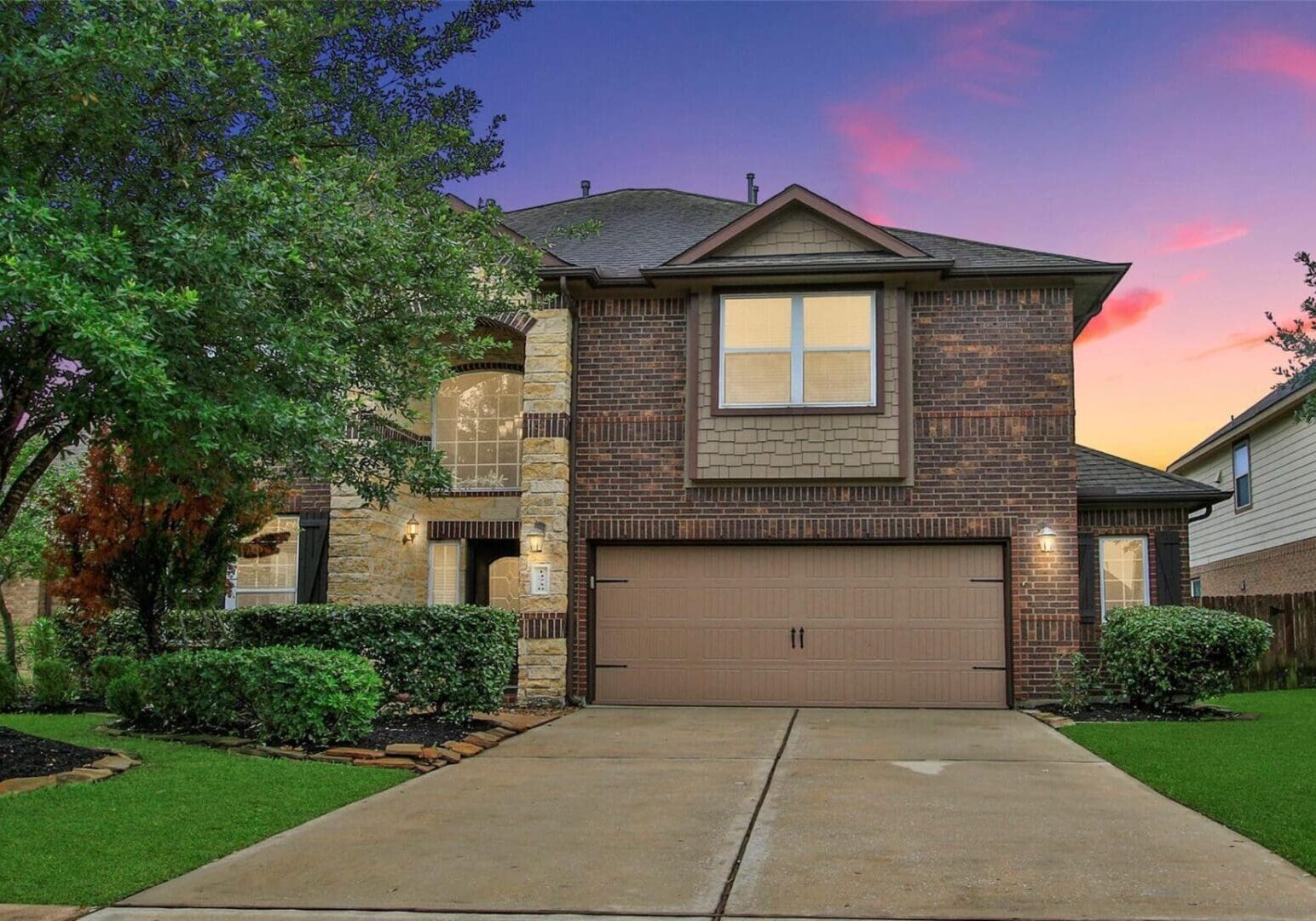 A large brick house with a garage door.