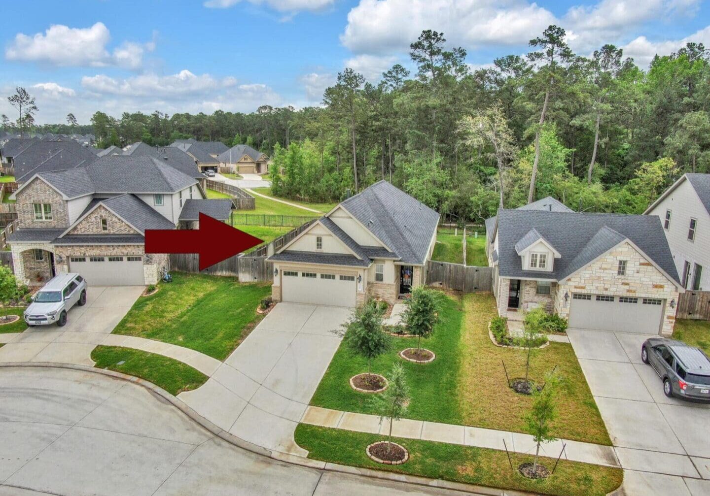 A aerial view of a house with the arrow pointing to it.