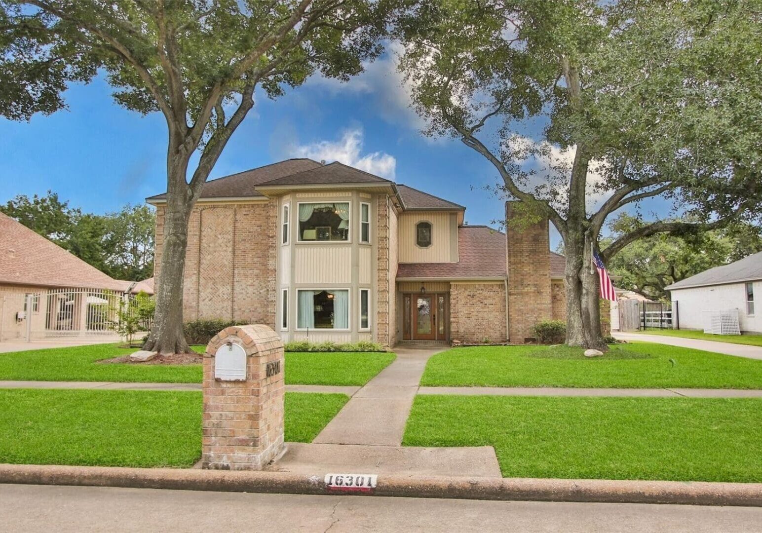 A house with trees and grass in front of it